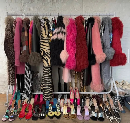 Rack of colorful faux fur coats and designer heels